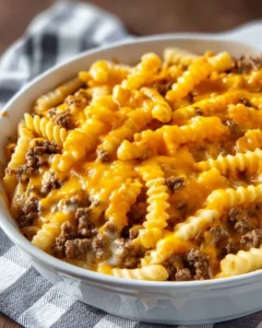 Delicious French Fry Casserole Bake topped with melted cheese and crispy bacon.