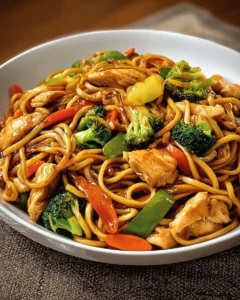 Plate of Garlic Chicken Lo Mein with colorful vegetables in a savory sauce