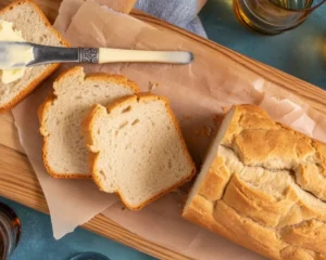 Loaf of homemade beer bread with a golden crust and soft interior.