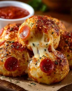 Cheesy pepperoni pizza bombs served on a plate