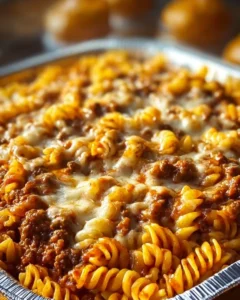 Cheesy Sloppy Cheeseburger Pasta topped with melted cheese and fresh herbs.