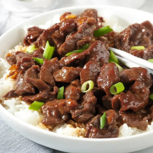 Delicious Mongolian Beef stir-fry served on a plate with vegetables.