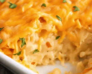 Delicious hashbrown casserole topped with melted cheese and crunchy cornflakes