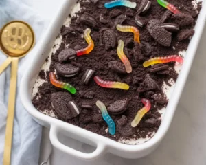 Delicious dirt cake made with Oreo cookies, creamy filling, and gummy worms.