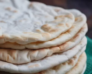 Fluffy homemade pita bread freshly baked, perfect for sandwiches or dips.