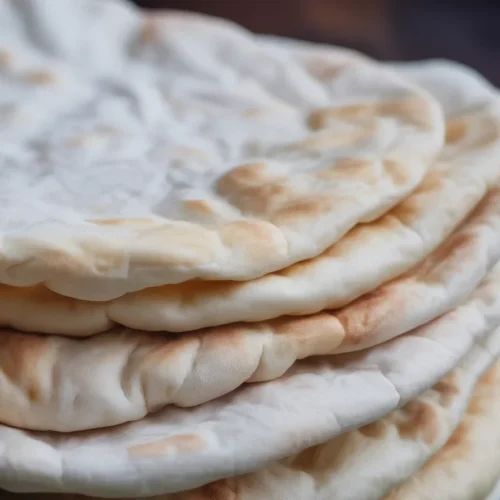 Fluffy homemade pita bread freshly baked, perfect for sandwiches or dips.