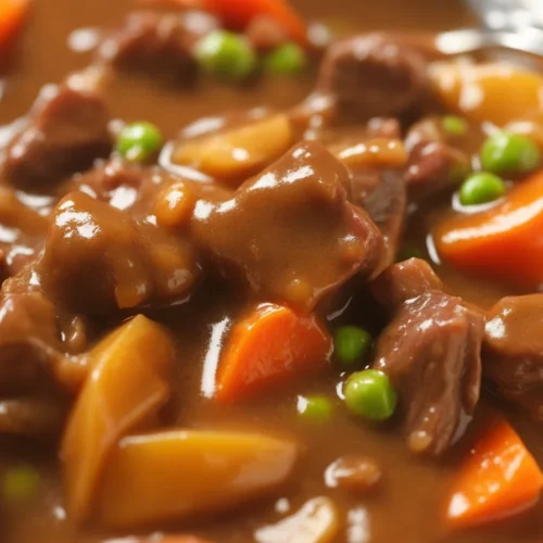 Delicious homemade beef stew in a crock pot with tender beef, potatoes, and vegetables.