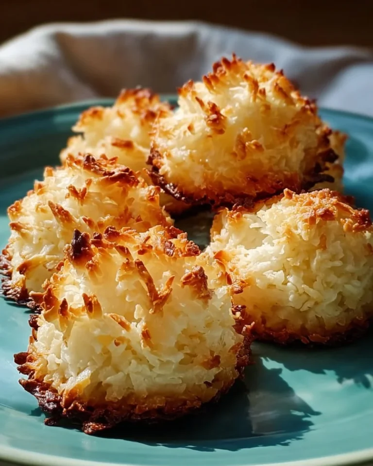 Delicious coconut macaroons on a decorative plate, showcasing their flaky texture.