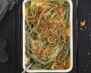 Delicious green bean casserole garnished with crispy fried onions.