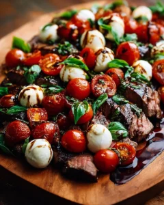 Grilled Steak Caprese topped with fresh basil and balsamic reduction