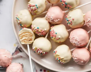 A delicious assortment of homemade cake pops covered in chocolate and sprinkles.