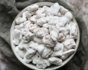 Delicious muddy buddies made with chocolate, peanut butter, and Chex cereal.