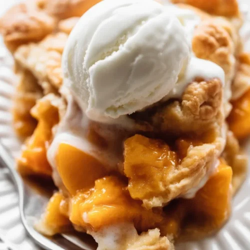 Delicious homemade peach pie with a flaky crust and juicy peach filling.