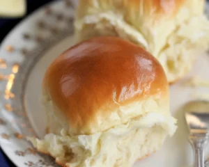 Homemade dinner rolls fresh out of the oven, golden and fluffy.