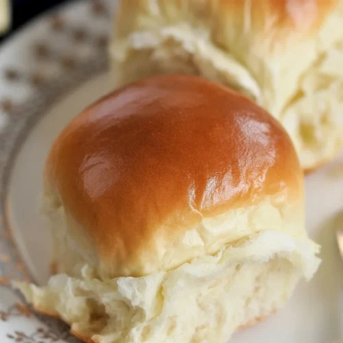 Homemade dinner rolls fresh out of the oven, golden and fluffy.