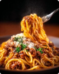 Plate of Spaghetti Bolognese with meat sauce and herbs