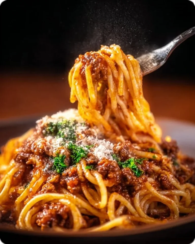 Plate of Spaghetti Bolognese with meat sauce and herbs