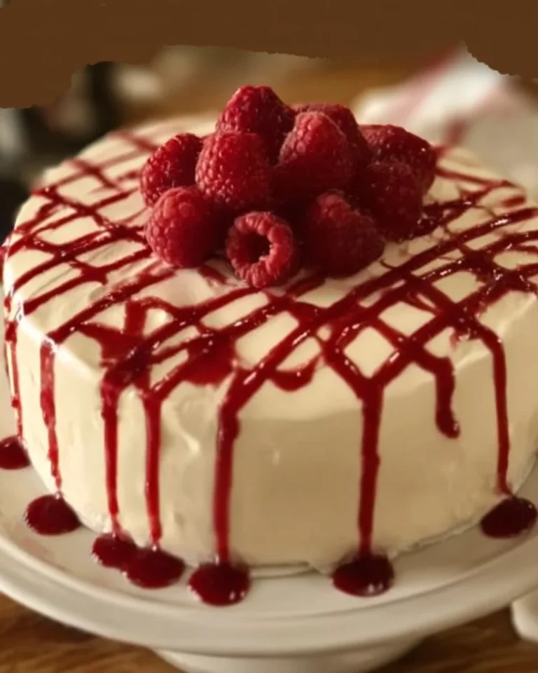 Delicious white chocolate raspberry mousse cake layered with fresh raspberries
