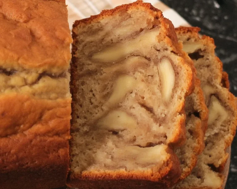 Moist banana bread made with oil, no butter, featuring ripe bananas and a golden crust.