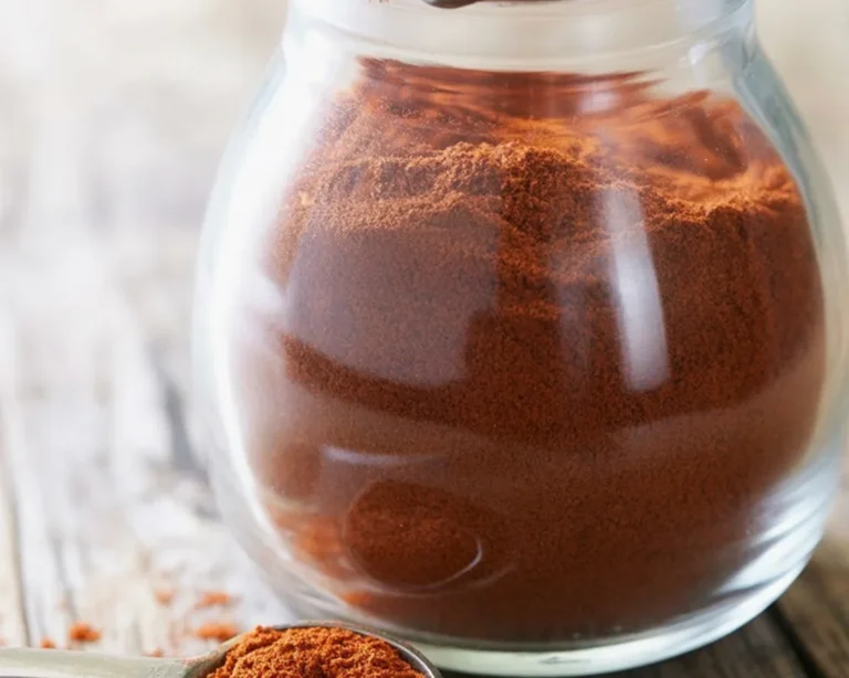 A colorful bowl of homemade chili powder with spices like paprika and cumin.