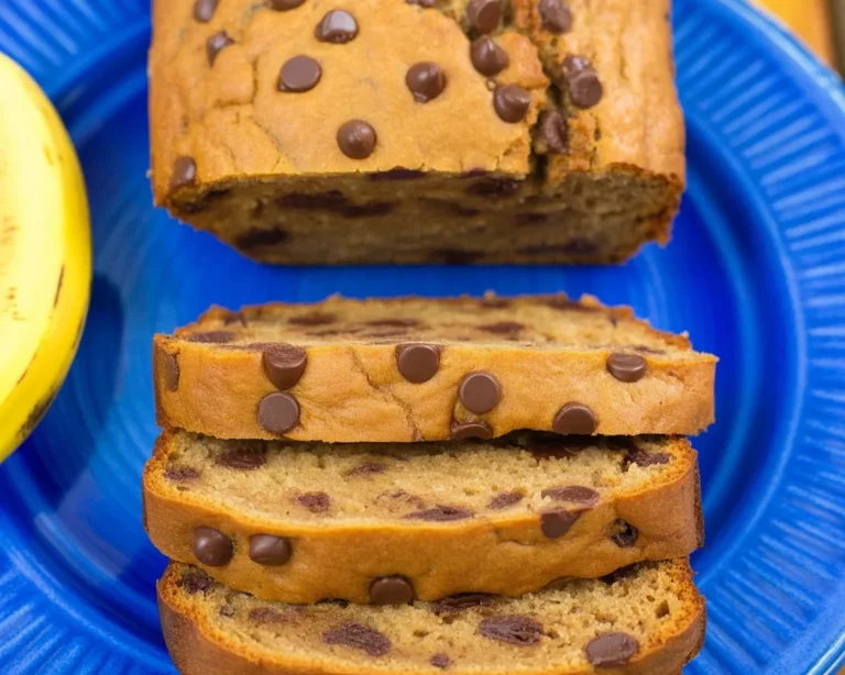 Sliced protein banana bread with nuts and banana on a wooden board