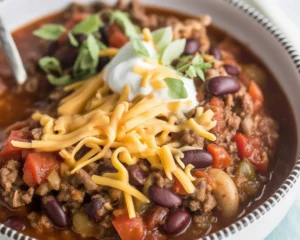 A hearty bowl of venison chili made with ground venison, beans, and tomatoes.
