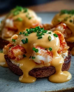 Delicious Bay Lobster Eggs Benedict topped with Cajun Hollandaise sauce