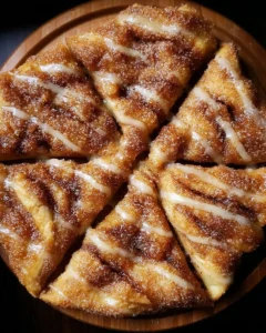 Cinnamon-sugar pizza made with crescent rolls, drizzled with icing.