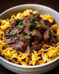Crockpot Mississippi Beef and Noodles served with fresh herbs and a side