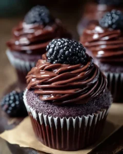 Delicious dark chocolate blackberry cupcakes topped with creamy frosting