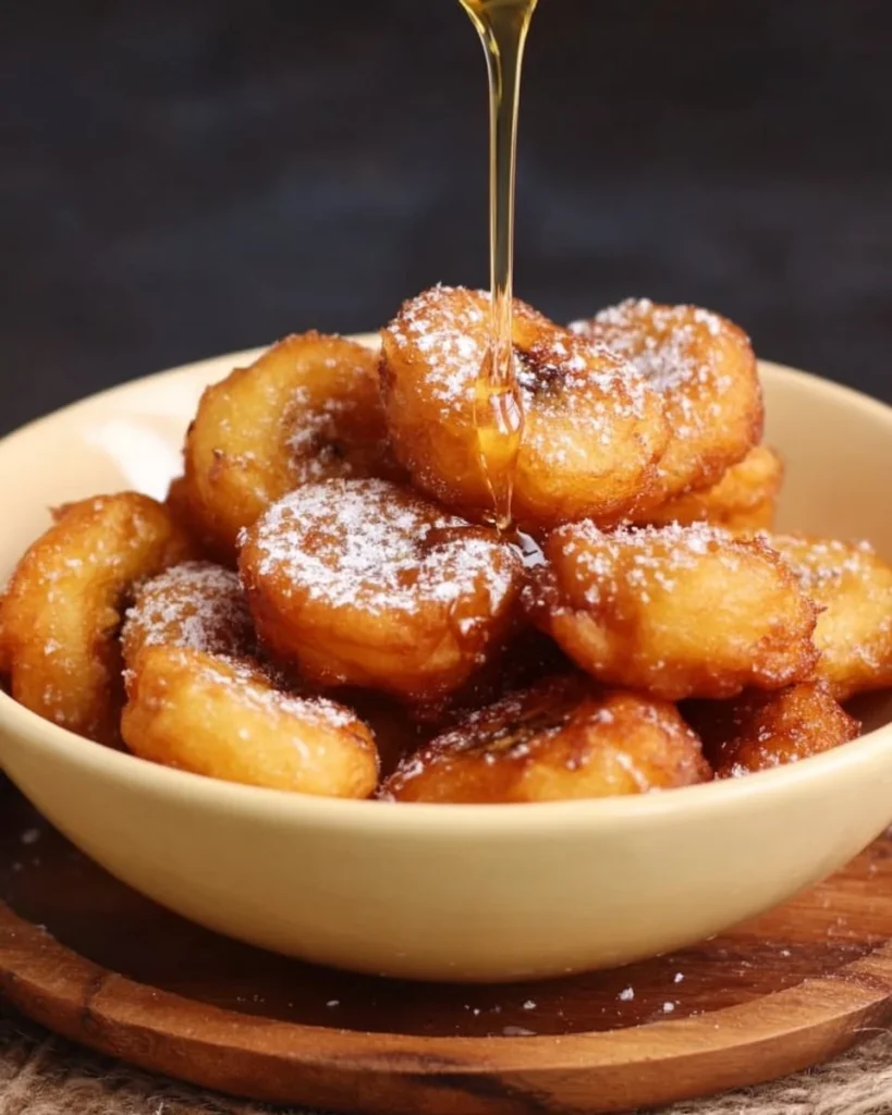 Plate of crispy Fried Banana Bites served with a dipping sauce.