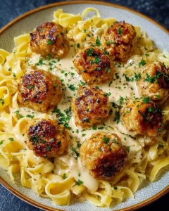 Garlic Butter Chicken Balls served with creamy Parmesan pasta on a plate.
