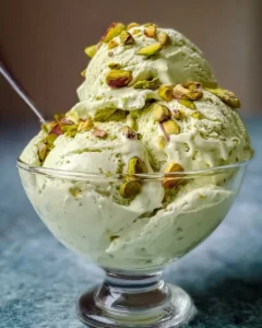A bowl of high protein pistachio ice cream topped with crushed pistachios