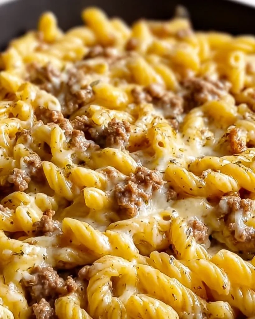 Creamy Loaded Cheeseburger Alfredo Pasta served in a bowl with garnishes.
