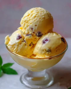 Bowl of homemade passion fruit ice cream topped with fresh fruits