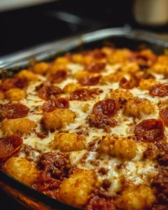 Delicious Tater Tot Pizza Casserole topped with melted cheese and toppings.