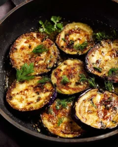 Delicious pan fried eggplant with minimal oil, served on a plate.