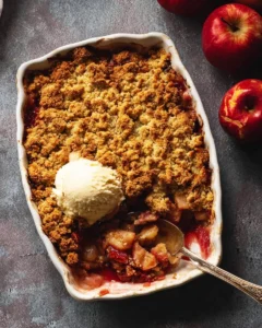 Apple and Rhubarb Crumble served in a baking dish with a golden crust