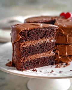 Delicious homemade chocolate cake topped with chocolate frosting and sprinkles