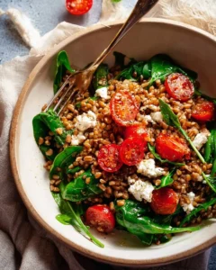 Farro Salad topped with Sizzled Garlic Dressing and fresh vegetables