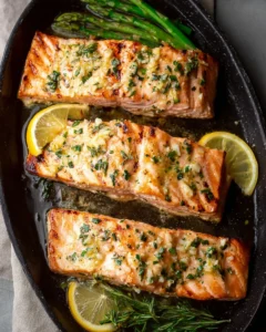 Grilled garlic butter salmon served with lemon and herbs