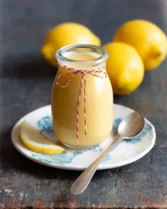 Delicious lemon sauce drizzled over a dessert, showcasing its vibrant color.