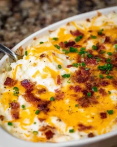 Delicious loaded mashed potato casserole topped with cheese and bacon