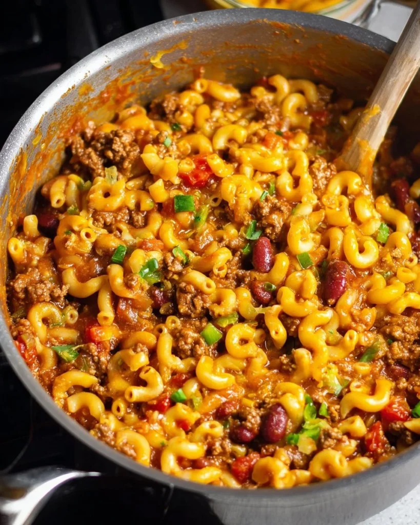 One Pot Chili Mac dish served in a bowl with cheese and herbs