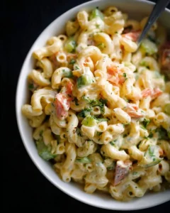 Delicious serving of macaroni salad with vegetables and dressing.