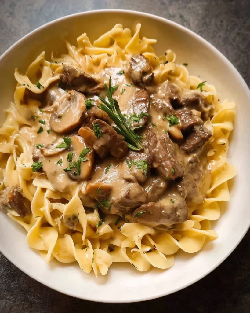 Creamy Beef Stroganoff with tender beef and mushrooms served on pasta