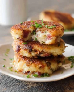 Delicious leftover mashed potato cheese and bacon cakes served on a plate.