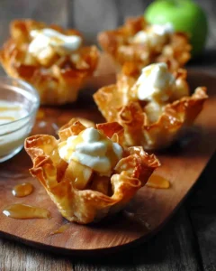 Mini apple pie wonton cups topped with cinnamon and caramel