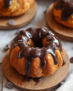 Mini pumpkin bundt cake with chocolate rum glaze on a decorative plate
