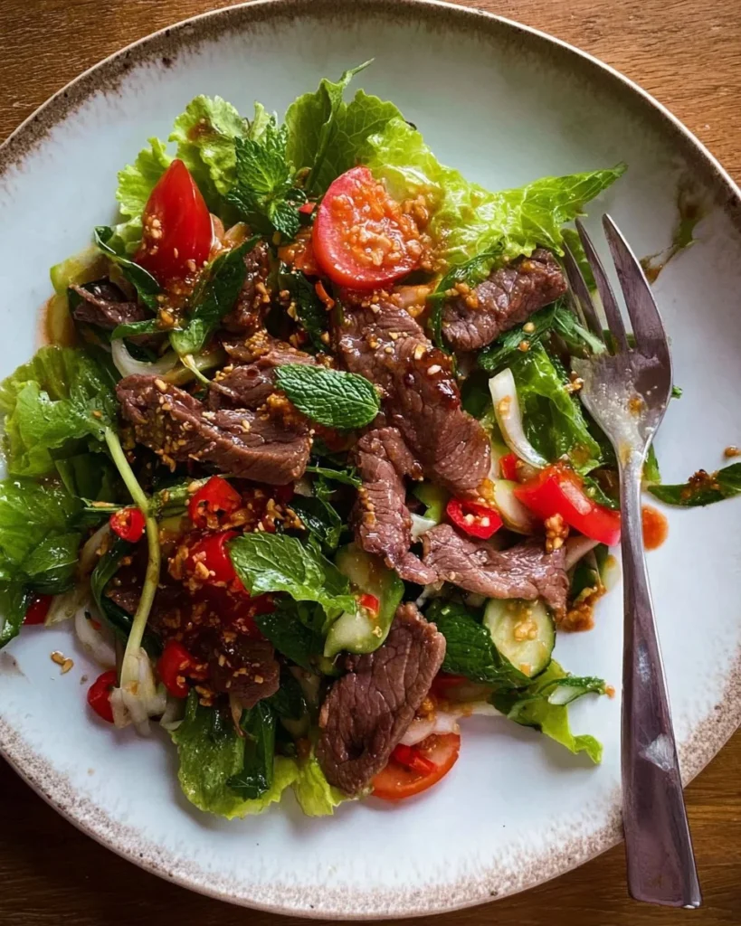 Delicious Thai Beef Salad with fresh herbs and vegetables on a plate